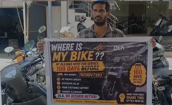 திருப்பூரில் ஓலா ஷோரூம் முன் கேக் வெட்டி போராட்டம் நடத்திய இளைஞர் சந்தோஷ்