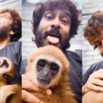 நடிகர் விக்ரம் குட்டிக் குரங்குடன் விளையாடும் காட்சி