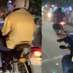 இருசக்கர வாகனத்தில் லேப்டாப்பை பயன்படுத்தும் இளைஞர்