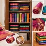 சேலைகளை மடித்து பீரோவில் அடுக்கி வைக்கும் காட்சி